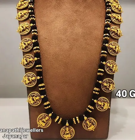 A kasu mala on black beads, captioned 40 grams