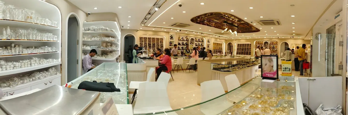The wide view of the hall: customers seated along the counter beneath a gold ceiling feature.